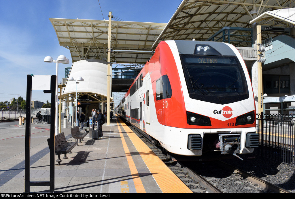 A southbound early afternoon Caltrain arrives into the station with Stadler KISS MU Car # 310 in the lead